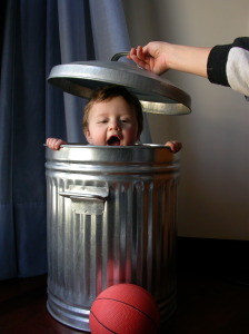 child in a garbage can